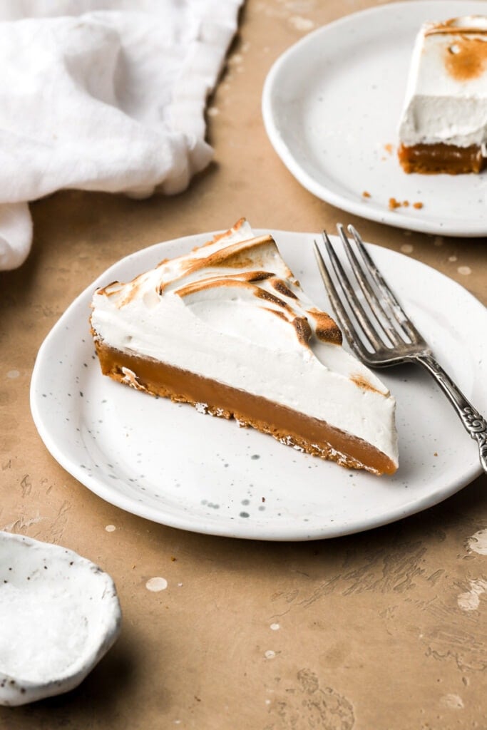 slice of caramel tart on a plate with a fork