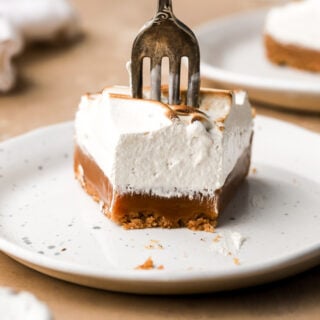 slice of caramel tart with the fork going through