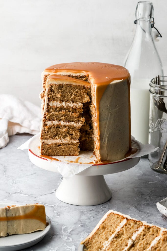 maple spice cake on a cake stand with slices around it