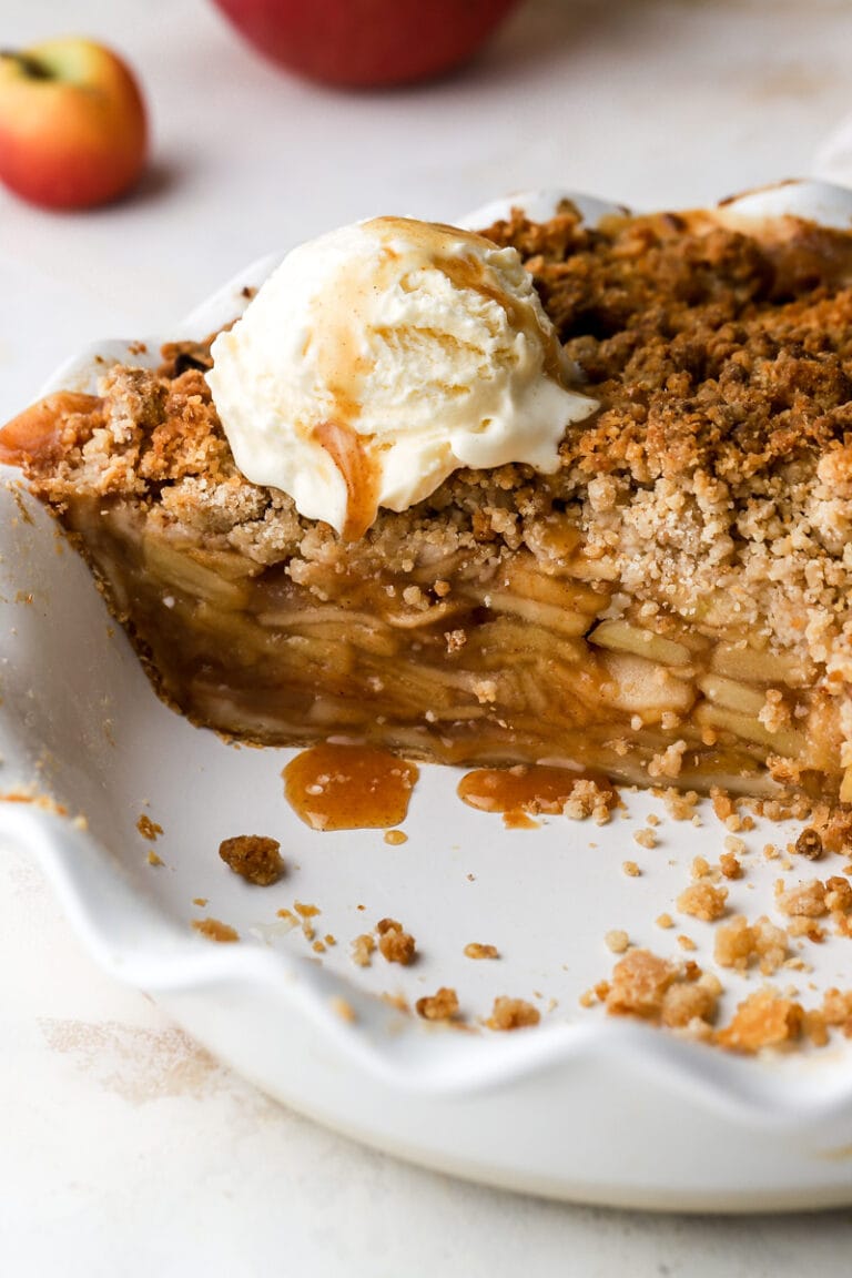 dutch apple pie cut into with ice cream and caramel on top