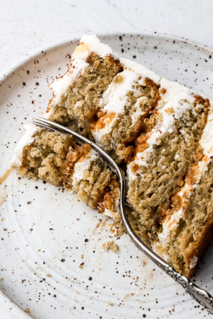 slice of banoffee cake on a plate with a bite taken out