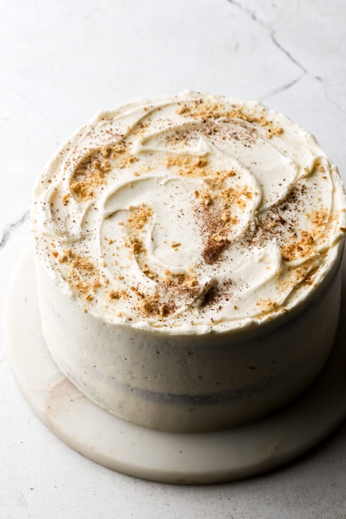 cake frosted with buttercream and topped with graham crackers and chocolate shavings.