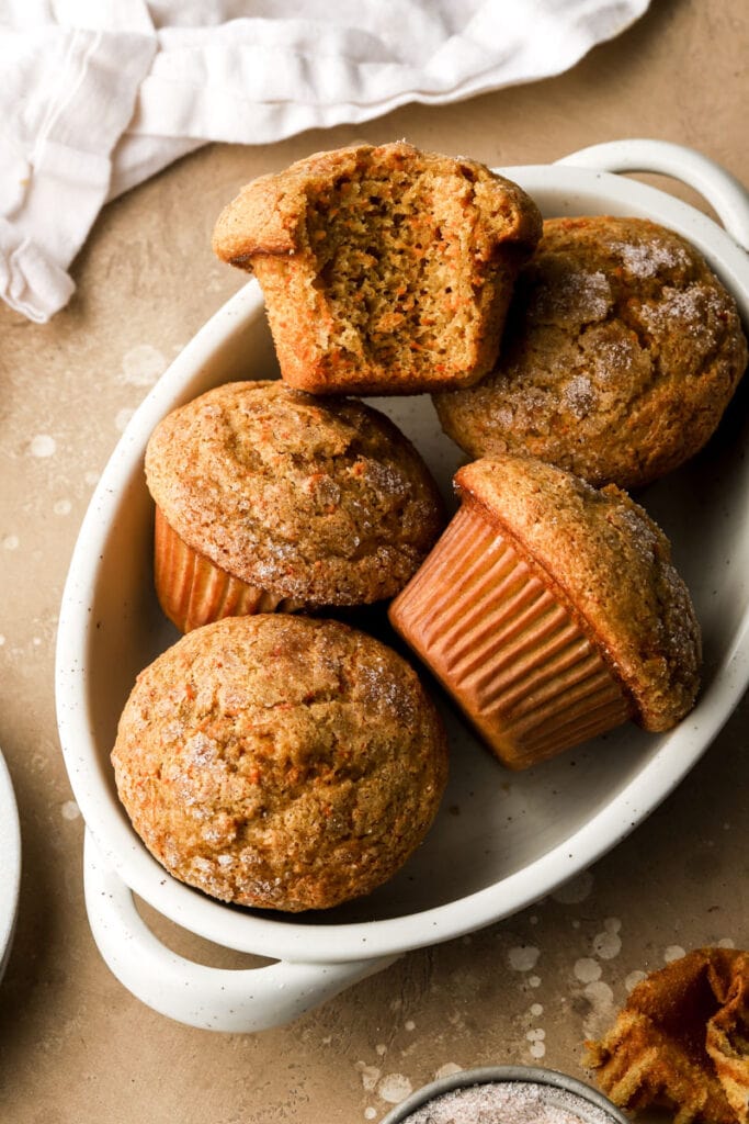 carrot cake muffins in a bowl with a bite taken out