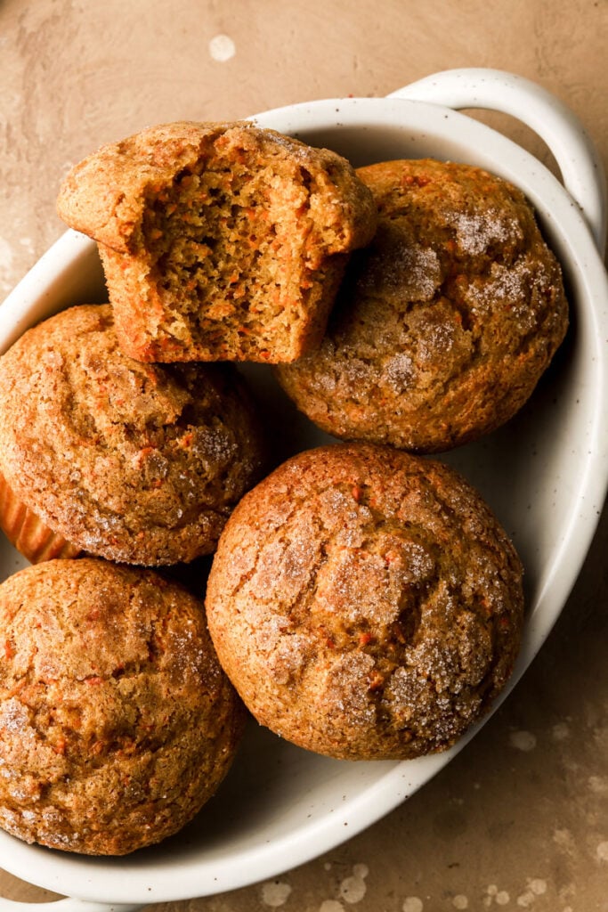 carrot cake muffins in a bowl with a bite taken out