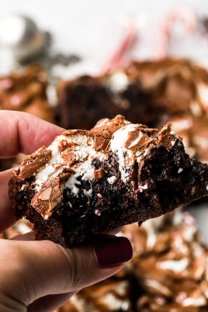 hand holding peppermint brownie with marshmallow fluff