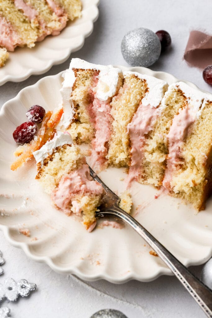 slice of cranberry orange cake on a plate with fork