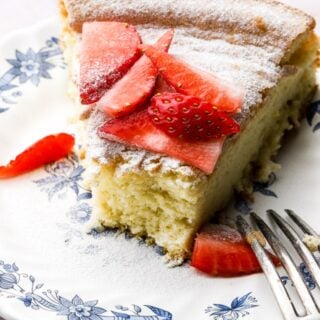 slice of cake on a plate with strawberries