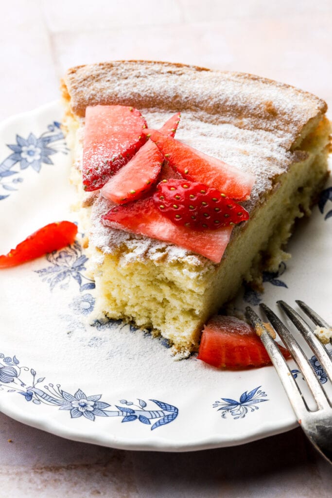 slice of cake on a plate with strawberries