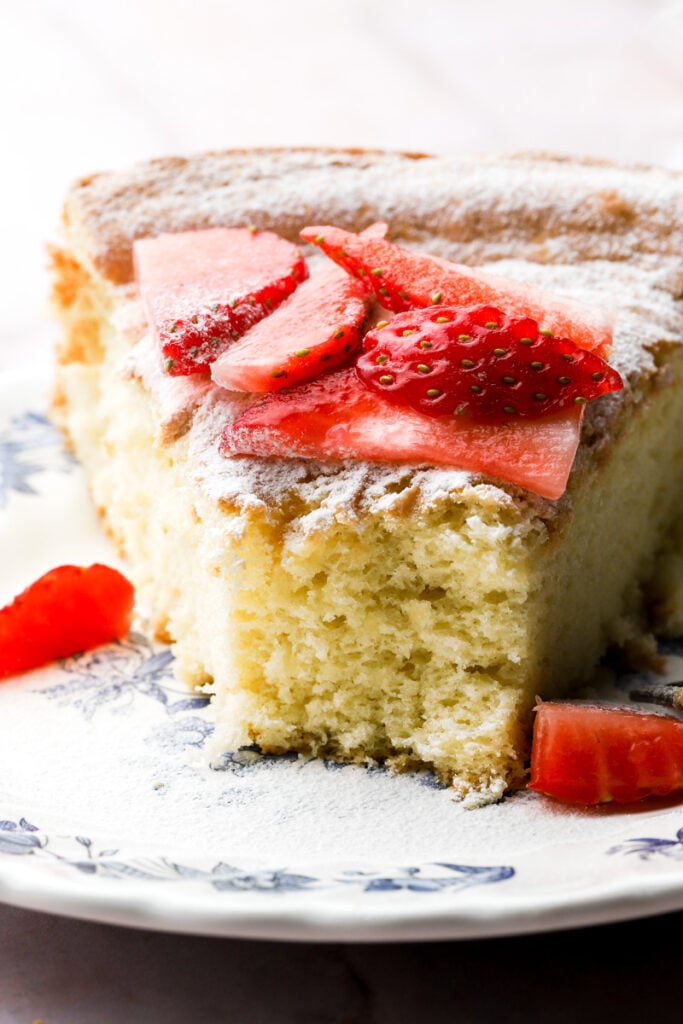 slice of cake on a plate with strawberries