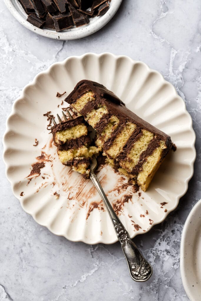 slice of prinzregententorte on a plate with a few bites taken out