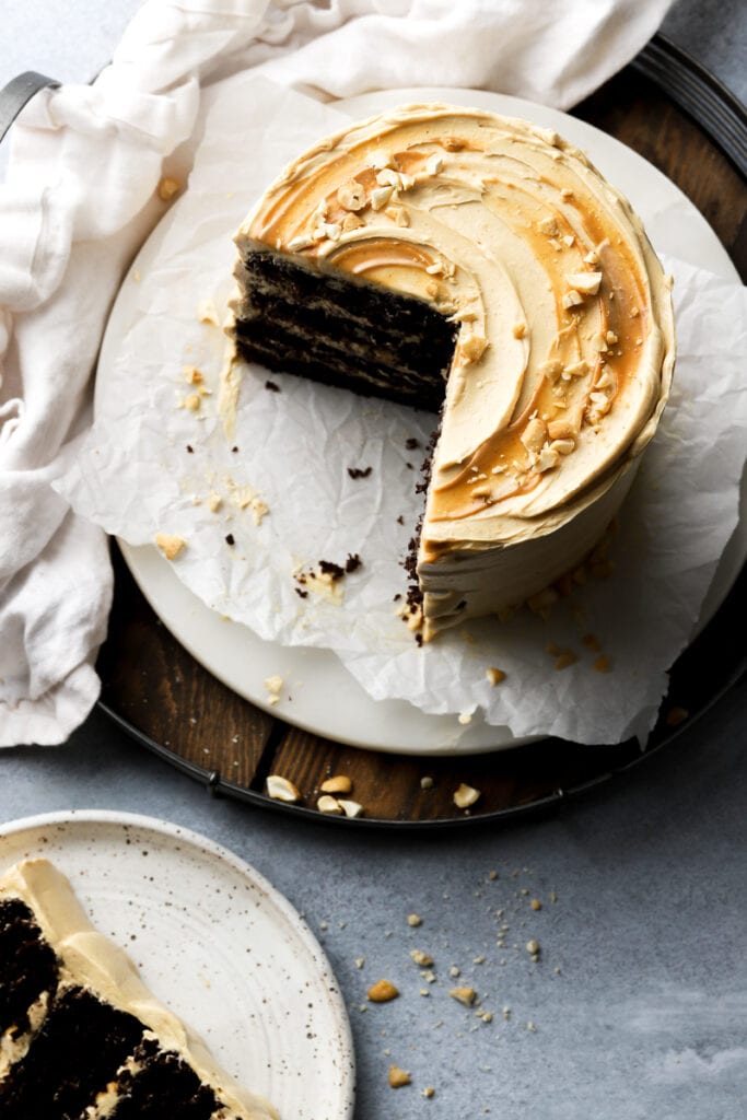chocolate peanut butter cake on a marble board with a slice next to it