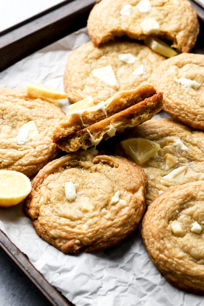 white chocolate lemon cookies on a cookie sheet, showing inside texture