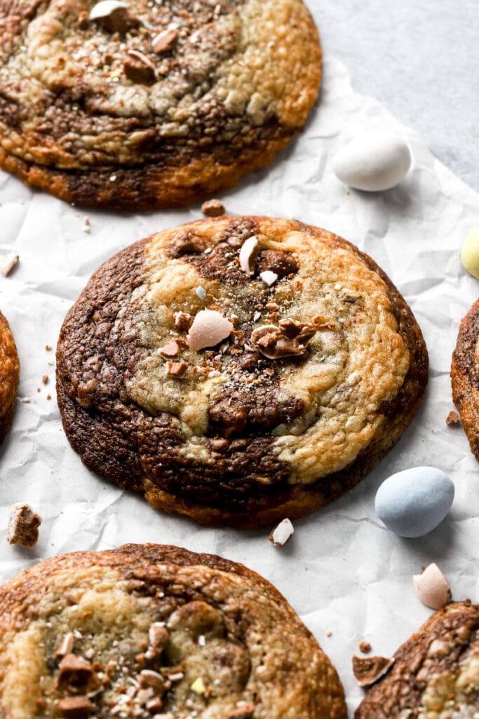 cookies on a parchment paper with cadbury mini eggs