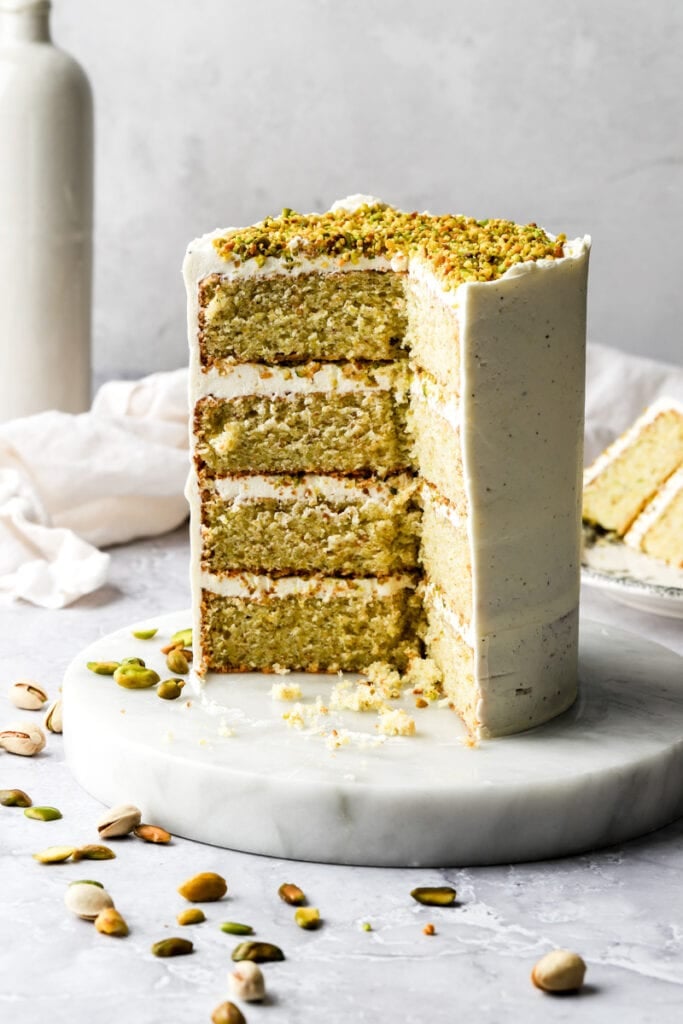 four layer pistachio cake with white frosting