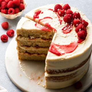 white chocolate raspberry cake with a slice taken out