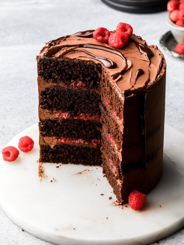 chocolate raspberry cake with chocolate drip and fresh raspberries