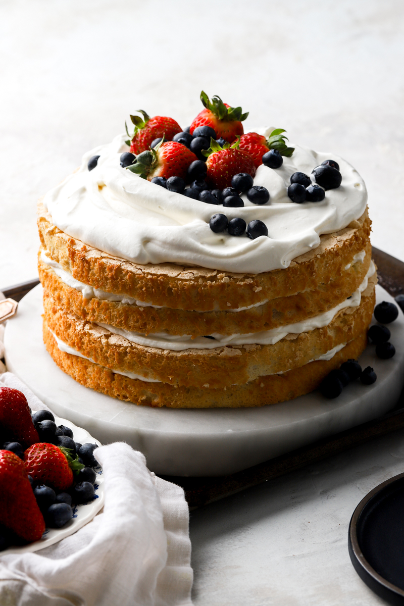finished chantilly cake topped with fresh berries