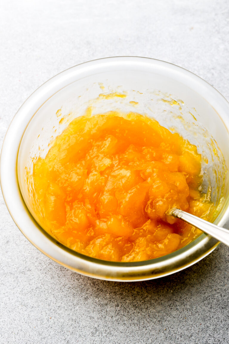 mango jam in a bowl with a spoon