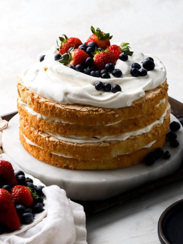 finished chantilly cake topped with fresh berries