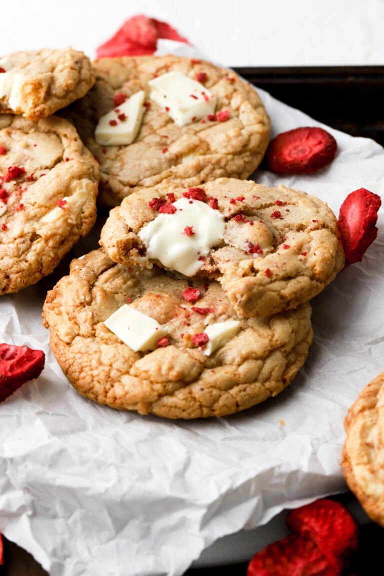 strawberry white chocolate chip cookies on a sheet of parchment paper