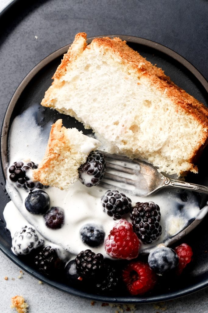 angel food cake with cream and berries on a plate