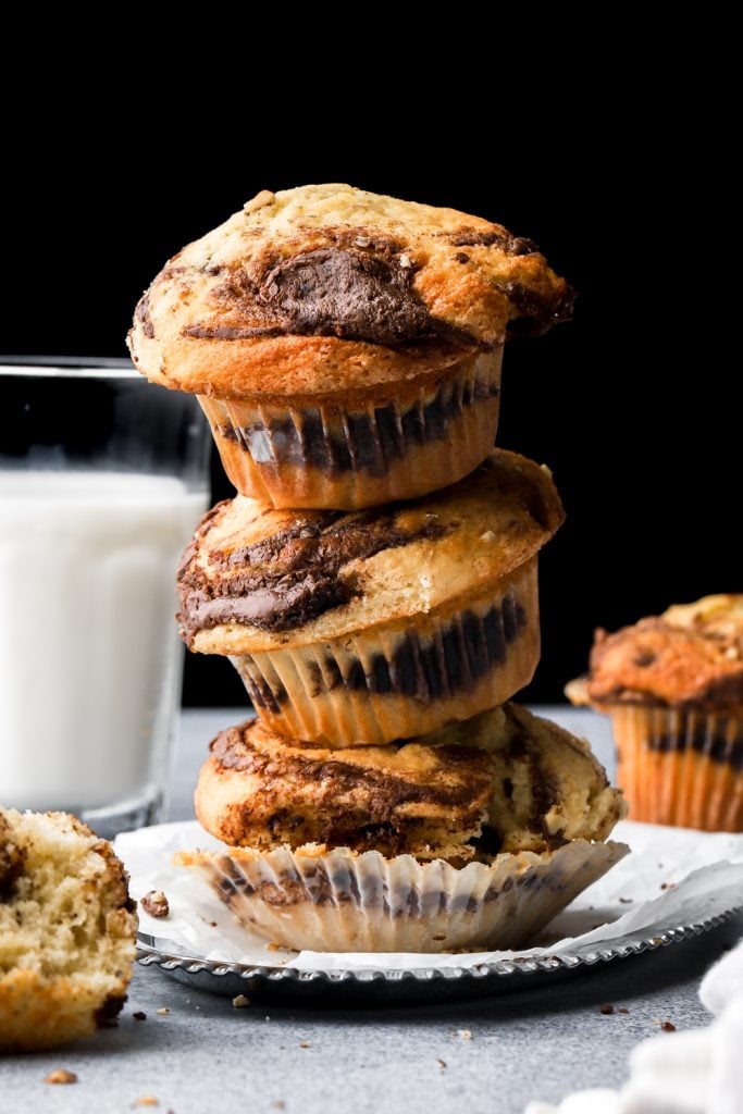 3 stacked nutella muffins next to a cup of milk