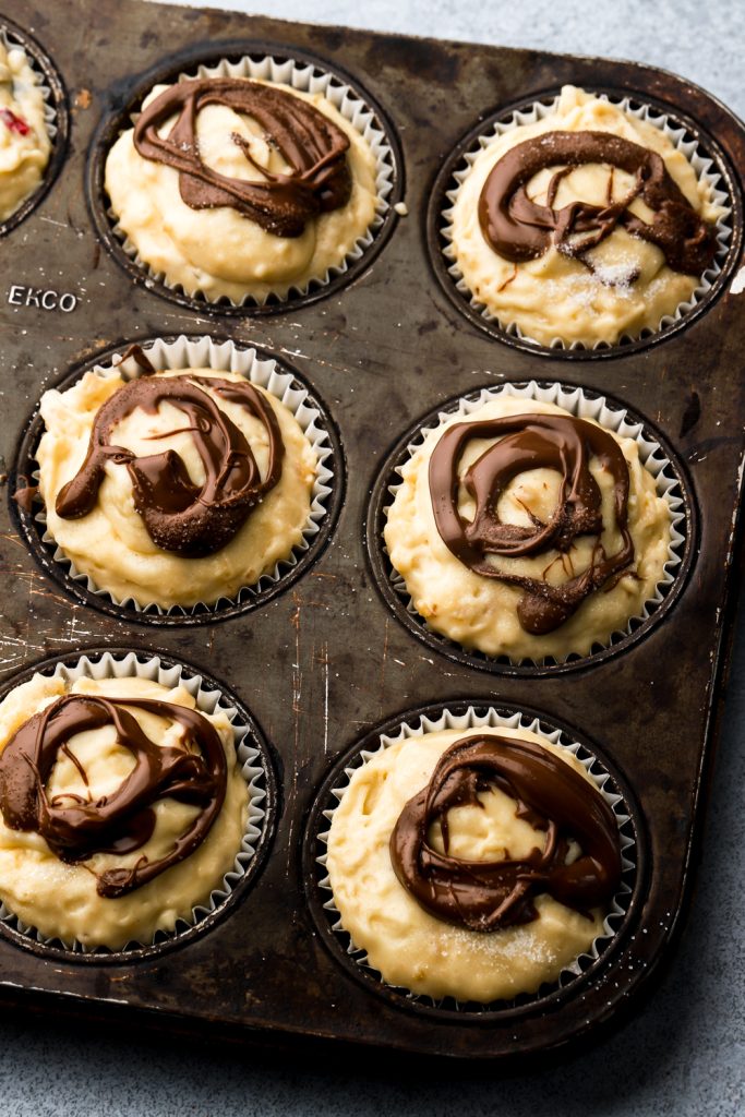 nutella muffin batter with globs of nutella on top