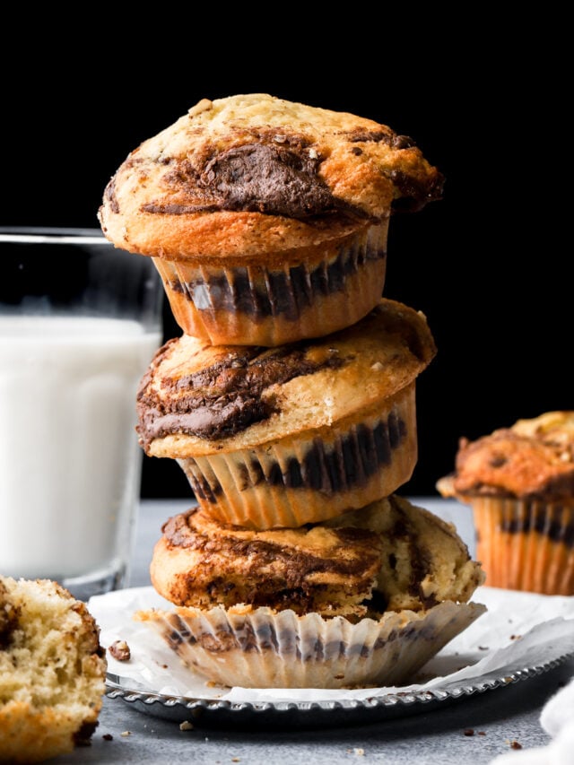3 stacked nutella muffins next to a cup of milk
