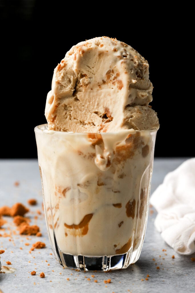 biscoff ice cream in a cup with a bite taken out