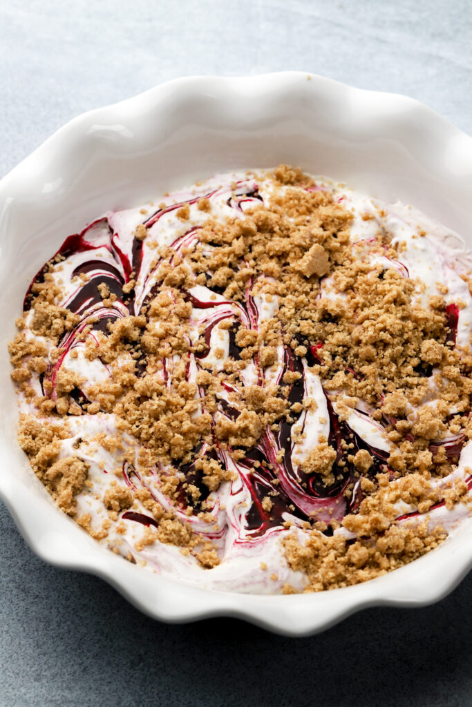 ice cream swirled with berry sauce and topped with streusel