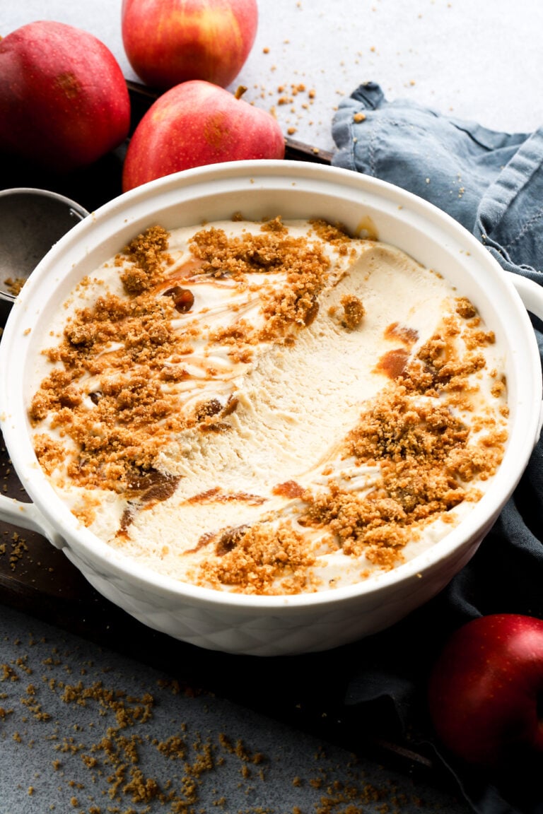 apple ice cream in a big bowl with a scoop missing from middle