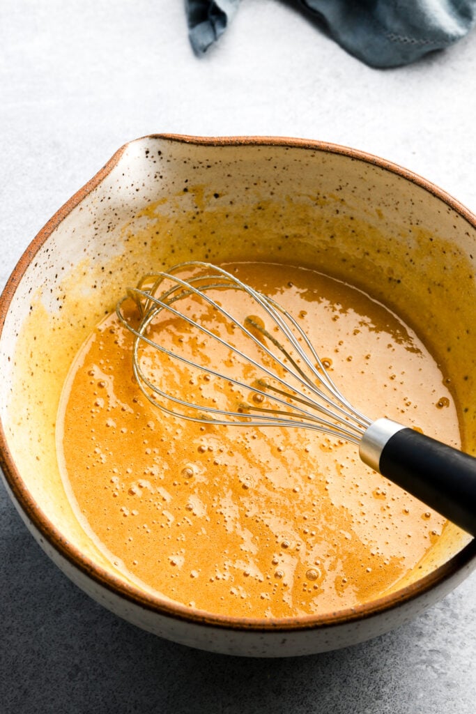 butter, sugar and eggs whisked together in a bowl