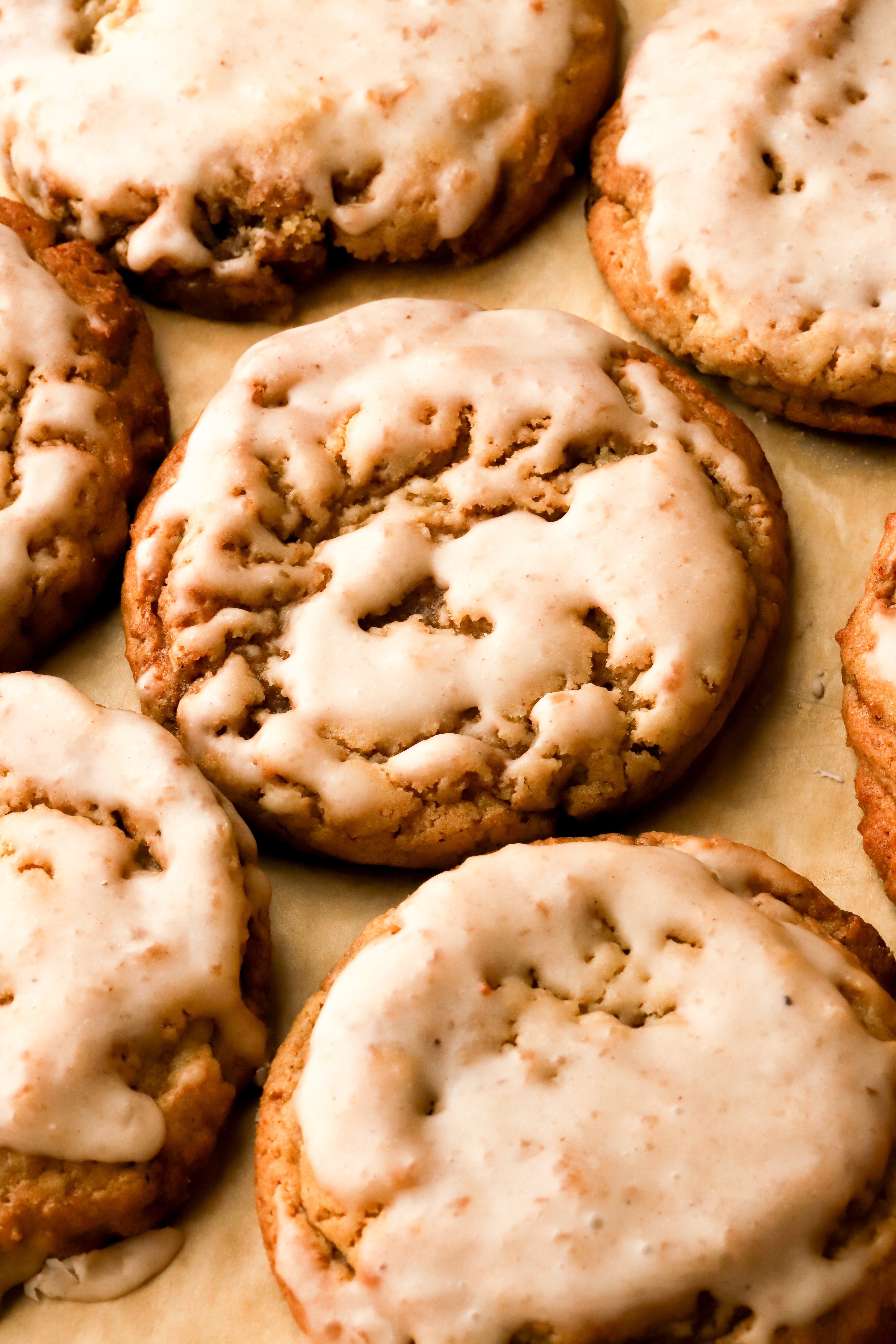 7 apple butter cookies on a pan dipped in icing