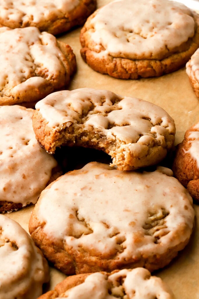 apple butter cookies dipped in icing - one cookie with a bite taken out