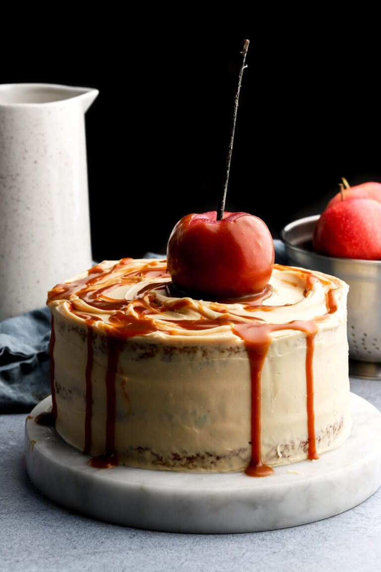 caramel apple cake topped with a caramel apple