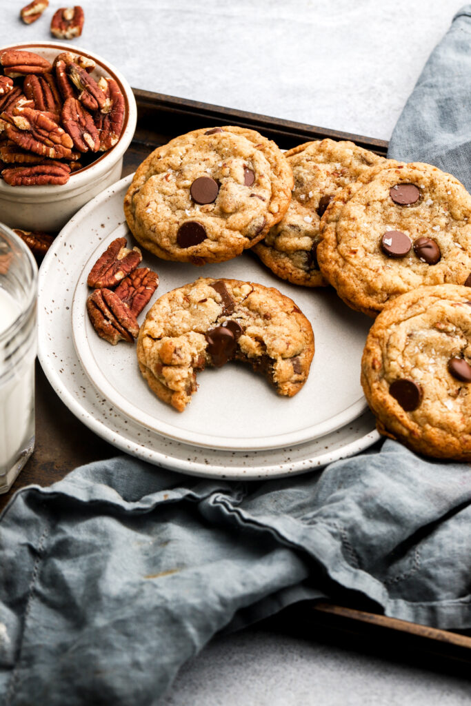 chocolate chip pecan cookies on a plate with milk