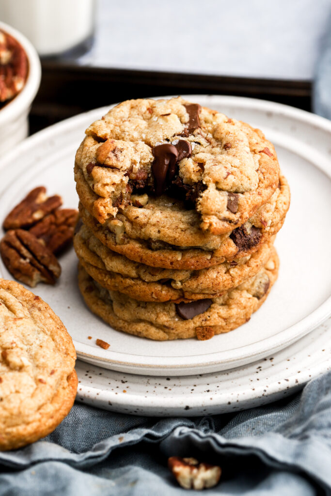 stack of cookies on a plate next to pecans