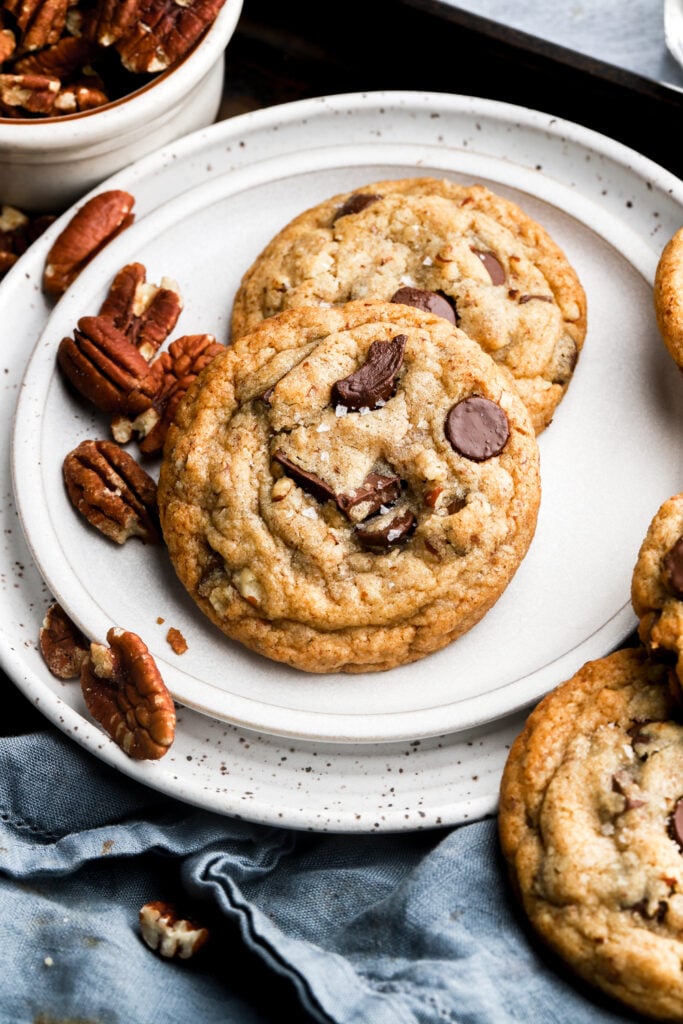 pecan chocolate chip cookies on a plate with pecans