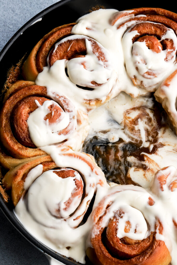 cinnamon roll covered in cream cheese frosting