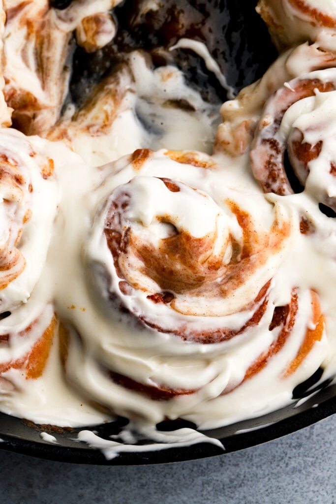 cinnamon roll covered in cream cheese frosting