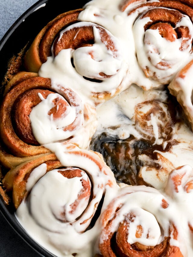 cinnamon roll covered in cream cheese frosting