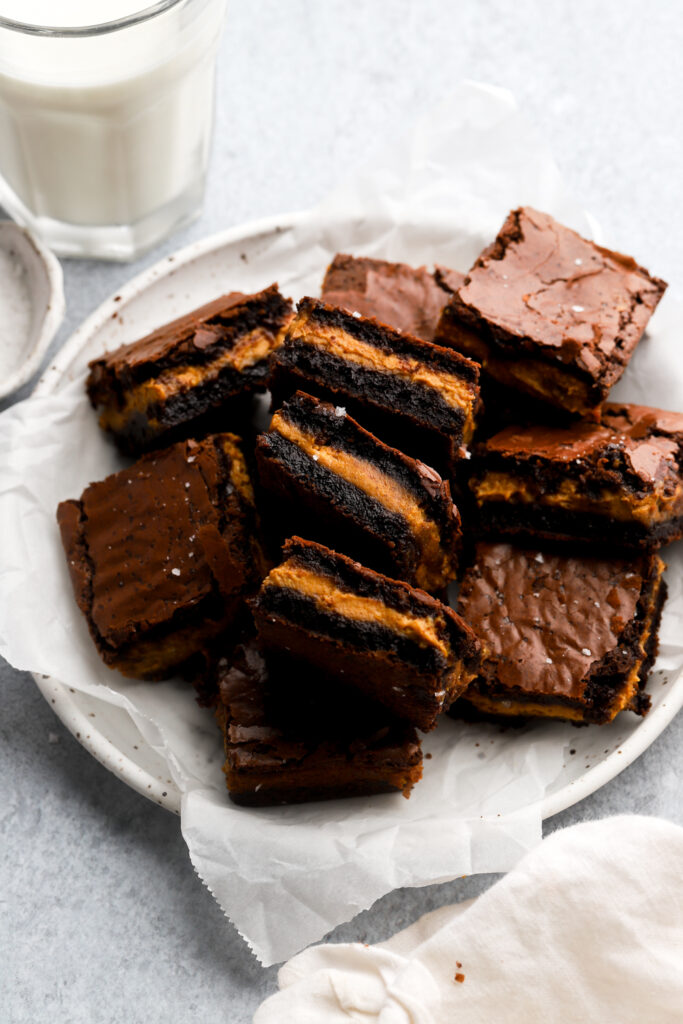 pumpkin brownies in a plate with a glass of milk