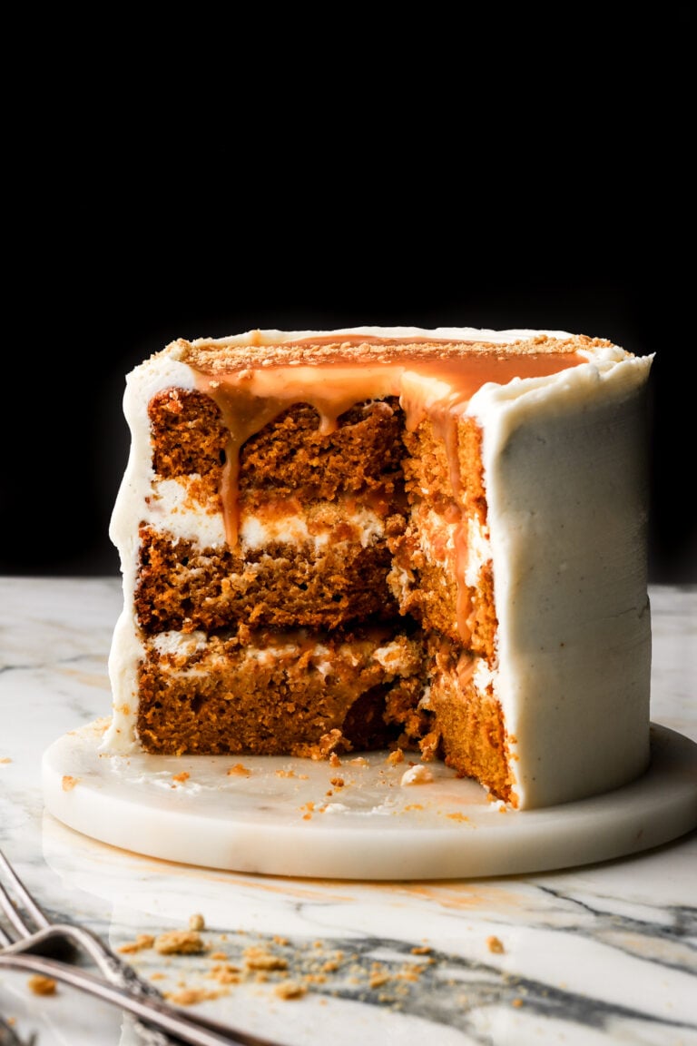 pumpkin cake on a marble surface with caramel dripping down