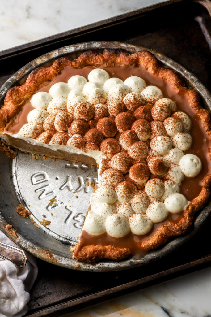 overhead of pie topped with whipped cream and cinnamon