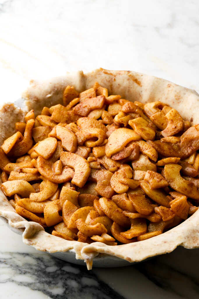 raw pie crust with apple pie filling