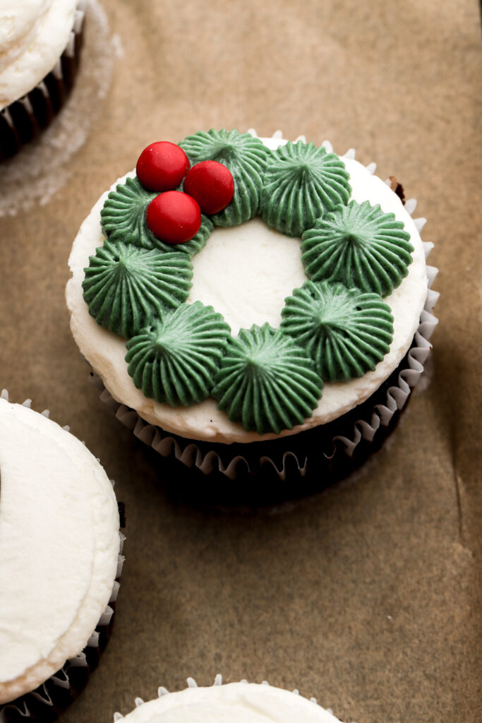 a wreath piped on top of a cupcake