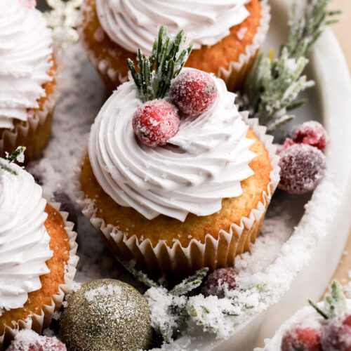 frosted cranberry cupcakes topped with sugared rosemary