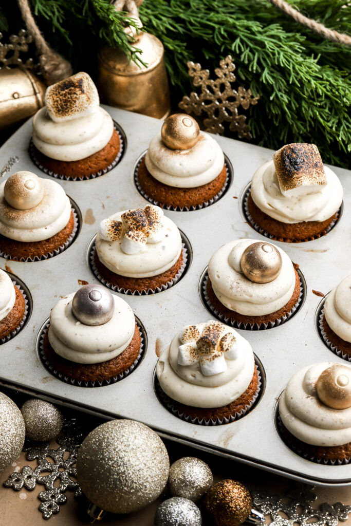 cupcakes topped with toasted marshmallows and truffles paint with gold dust