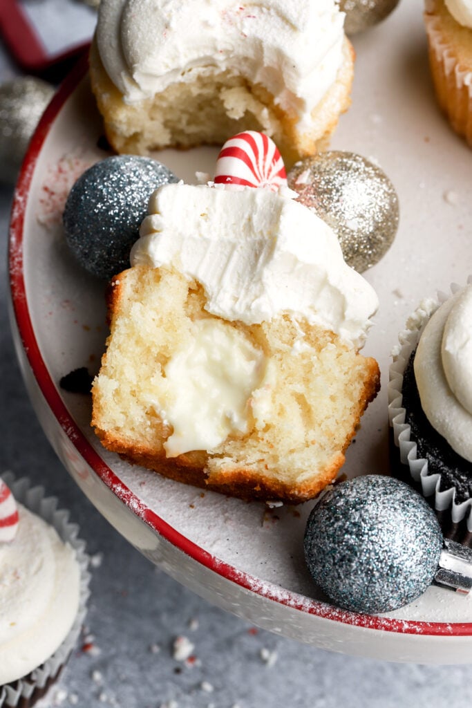 white chocolate peppermint cupcake cut in half with white chocolate peppermint truffle inside