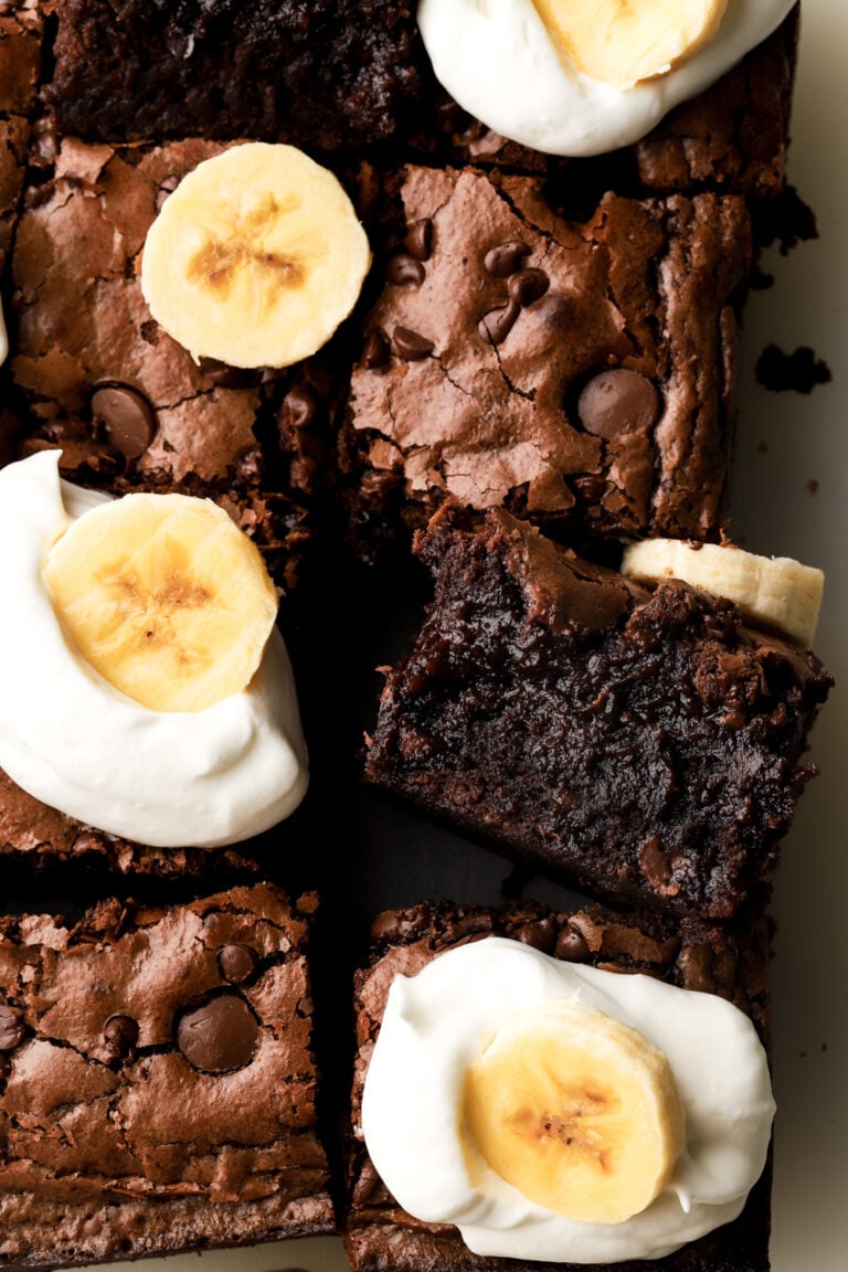 banana brownies topped with whipped cream and banana slices